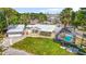 Charming home boasts a metal roof, inviting front porch, and screened-in pool, perfect for relaxation at 3620 E Tampa Cir, Tampa, FL 33629