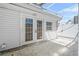 Backyard exterior featuring double doors and a small window that offer ample light into the home at 3620 E Tampa Cir, Tampa, FL 33629