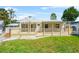 Beautiful porch featuring a railing system and a well-manicured lawn at 3620 E Tampa Cir, Tampa, FL 33629