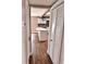 Hallway view showing kitchen island, modern lighting and wood look floors at 3620 E Tampa Cir, Tampa, FL 33629