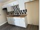 The kitchen features new cabinets, an eye-catching backsplash, and a butcher block countertop at 3620 E Tampa Cir, Tampa, FL 33629