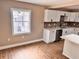 Well-lit kitchen with modern appliances, white cabinets, island and view to the outside at 3620 E Tampa Cir, Tampa, FL 33629