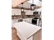 Modern kitchen with stainless steel appliances, white cabinets, island, and stylish backsplash at 3620 E Tampa Cir, Tampa, FL 33629