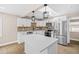 Well-lit kitchen features stainless steel appliances, white cabinetry, and a stylish backsplash at 3620 E Tampa Cir, Tampa, FL 33629