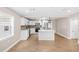 Modern kitchen boasts white cabinetry, stainless appliances, and island with pendant lighting at 3620 E Tampa Cir, Tampa, FL 33629