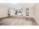 Open-concept living area with contemporary flooring, skylight, and access to the kitchen and bath at 3620 E Tampa Cir, Tampa, FL 33629
