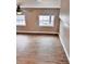 Living room with sleek wood flooring, neutral paint, and updated lighting at 3620 E Tampa Cir, Tampa, FL 33629