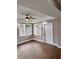 A spacious living room with modern floors, ceiling fan, and access to exterior entry at 3620 E Tampa Cir, Tampa, FL 33629
