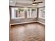 A spacious living room is brightened by natural light through numerous windows and featuring modern ceiling fan at 3620 E Tampa Cir, Tampa, FL 33629