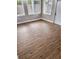 A spacious living room is brightened by natural light through numerous windows and featuring access to exterior entry at 3620 E Tampa Cir, Tampa, FL 33629