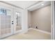 Bright room featuring tile flooring, neutral paint, and glass paneled doors leading to a patio at 3620 E Tampa Cir, Tampa, FL 33629