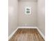 A small room showcasing luxury vinyl plank flooring and a single double hung window at 3620 E Tampa Cir, Tampa, FL 33629