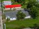Aerial view of renovated house with a well-manicured lawn in a quiet residential neighborhood at 602 E Laura St, Plant City, FL 33563