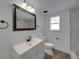 Bright bathroom with modern vanity, gray-toned tile shower, and dark bronze accents at 602 E Laura St, Plant City, FL 33563