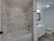 Updated bathroom features a tub with marble-look tile surround at 602 E Laura St, Plant City, FL 33563