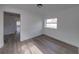 A bright bedroom features gray laminate floors and a view of outside at 602 E Laura St, Plant City, FL 33563