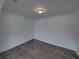 A bright bedroom features gray laminate floors and white walls at 602 E Laura St, Plant City, FL 33563