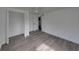 Bedroom showcasing new flooring, a closet, and an open doorway to the renovated bathroom at 602 E Laura St, Plant City, FL 33563