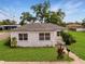 Charming white home featuring a well-maintained lawn and cozy front entrance at 602 E Laura St, Plant City, FL 33563