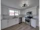 Modern kitchen with stainless steel appliances, white cabinets, and granite countertops, offering a stylish cooking space at 602 E Laura St, Plant City, FL 33563