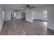 Spacious living room featuring modern flooring, white walls, and a ceiling fan for a bright, airy feel at 602 E Laura St, Plant City, FL 33563