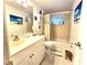 Well-lit bathroom featuring a vanity, tub, and shower at 7943 Woodvine Cir, Tampa, FL 33615