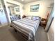 Bedroom with mirrored closet and nautical themed artwork at 7943 Woodvine Cir, Tampa, FL 33615