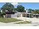 Charming single-story home with attached garage, carport, RV parking, and well-maintained lawn at 7943 Woodvine Cir, Tampa, FL 33615