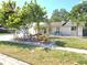 Charming single-story home featuring a well-manicured lawn and colorful landscaping at 7943 Woodvine Cir, Tampa, FL 33615