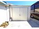 Closed garage exterior with metal doors, providing secure storage alongside RV parking at 7943 Woodvine Cir, Tampa, FL 33615