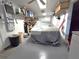 Spacious garage with ample storage, tools, shelving, and a car covered with a protective sheet at 7943 Woodvine Cir, Tampa, FL 33615