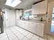 Bright white kitchen features updated cabinets, countertop, tiled floor and stainless steel appliances at 7943 Woodvine Cir, Tampa, FL 33615
