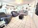 Cozy living room with tile floors, comfortable seating, and bright, airy atmosphere at 7943 Woodvine Cir, Tampa, FL 33615