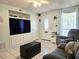Inviting living room featuring built-in storage, tile floors, and a welcoming front entrance at 7943 Woodvine Cir, Tampa, FL 33615