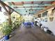 Outdoor dining area featuring an open-air structure with decorative features, potted plants and a grill at 7943 Woodvine Cir, Tampa, FL 33615