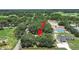 An aerial view shows the property surrounded by lush landscapes, offering a private, tranquil setting at 106 Corbett Rd, Lithia, FL 33547