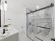 Stylish bathroom with a glass shower door, sleek fixtures, and patterned tile floor at 106 Corbett Rd, Lithia, FL 33547
