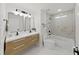 Modern bathroom featuring a double sink vanity, sleek fixtures, and a tub with marble-look tile surround at 106 Corbett Rd, Lithia, FL 33547