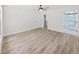 Large bedroom with hardwood floors, ceiling fan, and ensuite bathroom featuring glass shower doors at 106 Corbett Rd, Lithia, FL 33547