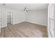 Spacious bedroom featuring hardwood floors, ceiling fan, and a closet with shelves at 106 Corbett Rd, Lithia, FL 33547