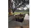 Beautiful landscaping featuring a large tree and flowers near the front porch columns that have stone accents at 106 Corbett Rd, Lithia, FL 33547