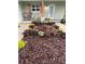 Up close image of the front yard landscaping with river rock, seasonal flowers, and wooden shutters flanking a window at 106 Corbett Rd, Lithia, FL 33547