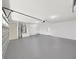 Spacious garage featuring epoxy floor, utility sink, and door to the side yard at 106 Corbett Rd, Lithia, FL 33547