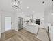Bright, modern kitchen with stainless steel appliances, large island, and wood-look flooring at 106 Corbett Rd, Lithia, FL 33547