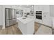 Elegant kitchen featuring stainless appliances, custom cabinets, island, and modern finishes at 106 Corbett Rd, Lithia, FL 33547