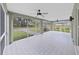 Screened-in porch overlooking a spacious backyard with mature trees and a concrete patio area at 106 Corbett Rd, Lithia, FL 33547