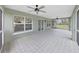 Screened-in porch with tile flooring overlooking the backyard, providing ample space for outdoor seating at 106 Corbett Rd, Lithia, FL 33547