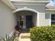 Charming front porch with decorative wreath, seating, and potted flowers at 13443 Graham Yarden Dr, Riverview, FL 33579