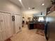 Open kitchen flowing into the dining and living areas with tile flooring at 13443 Graham Yarden Dr, Riverview, FL 33579