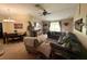 Inviting living room area with comfortable seating, ceiling fan, and ample natural light at 13443 Graham Yarden Dr, Riverview, FL 33579